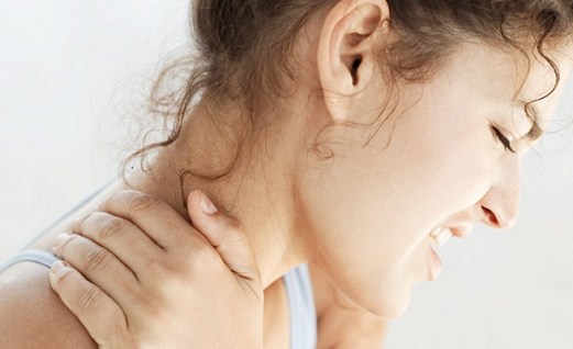 Young Woman Holding Her Neck in Pain